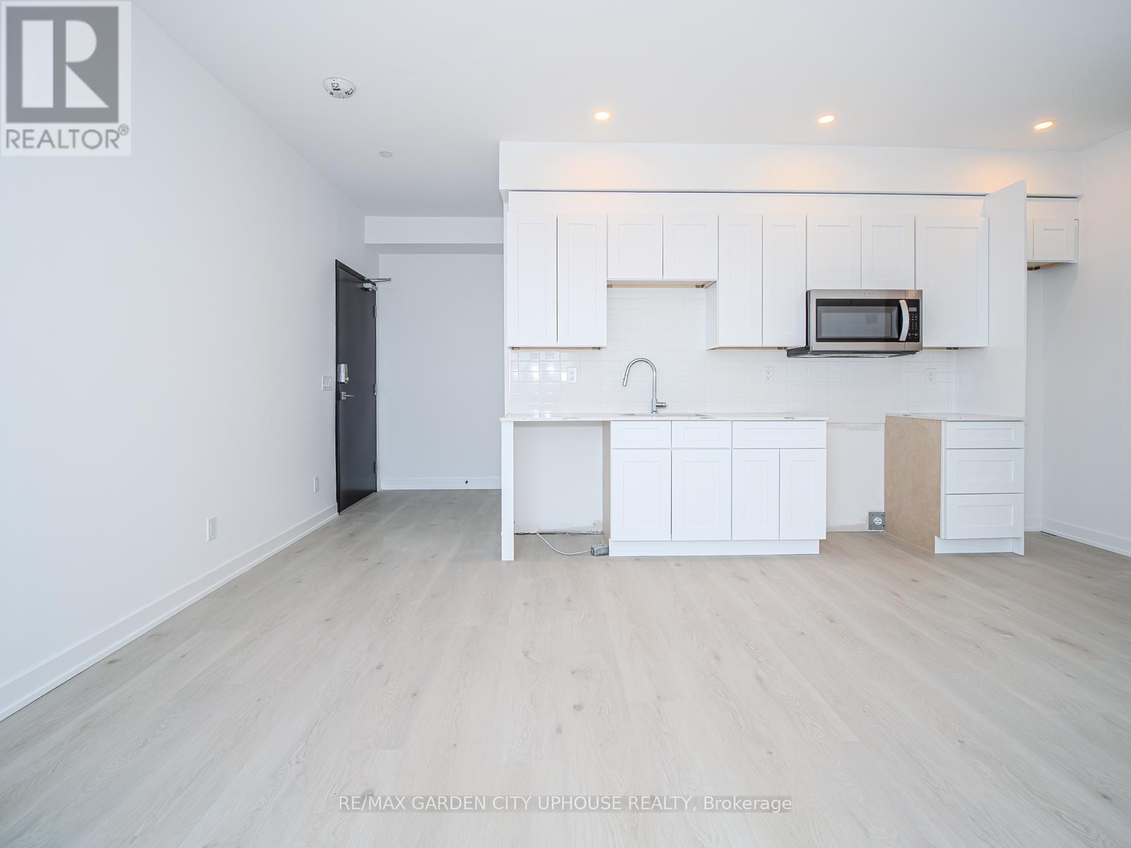 A white kitchen with a microwave above the stove.
