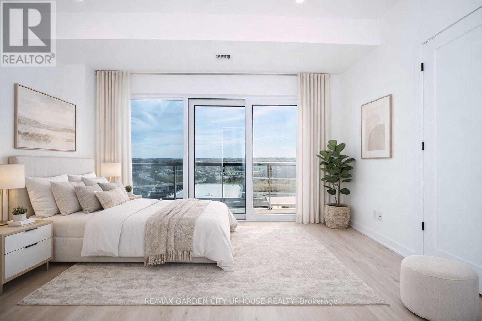 A bedroom with a large bed and a view of the ocean through the windows.