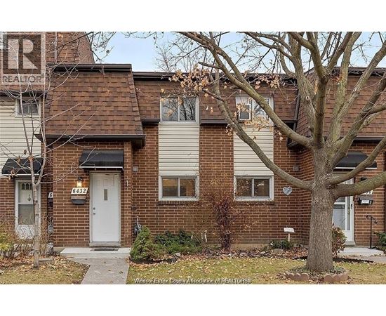 A house with a tree in front of it.