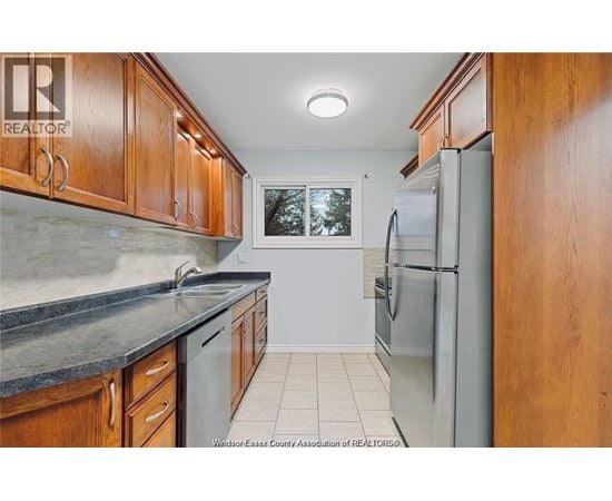 A kitchen with wooden cabinets and a refrigerator.