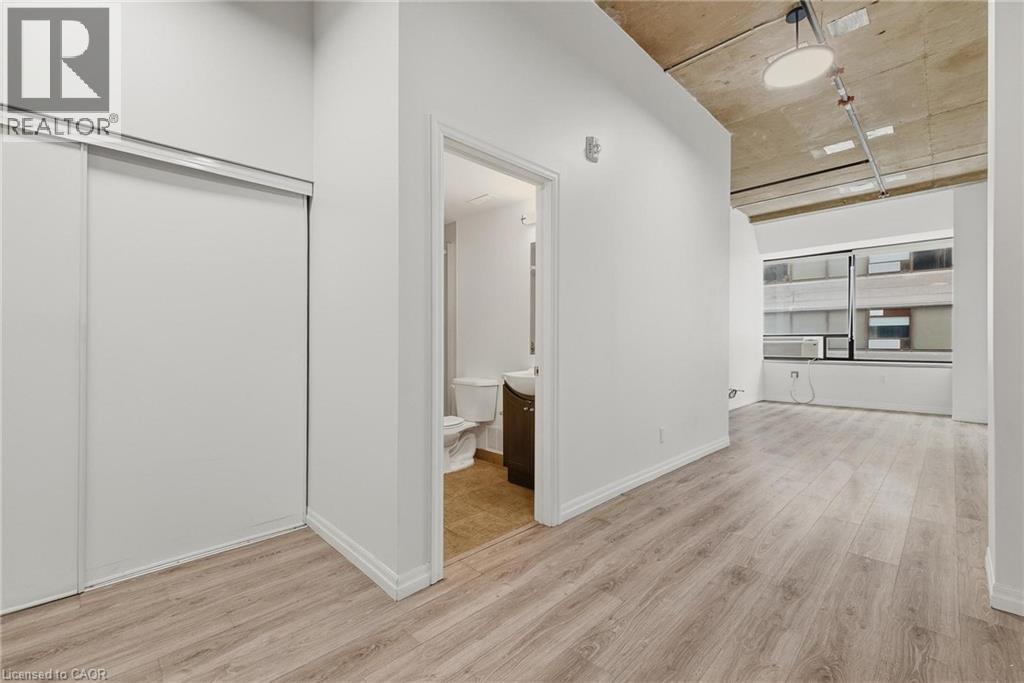 A room with a white door and a white wall with a logo on it.