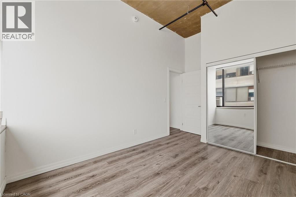 A room with wooden flooring and a sliding glass door.