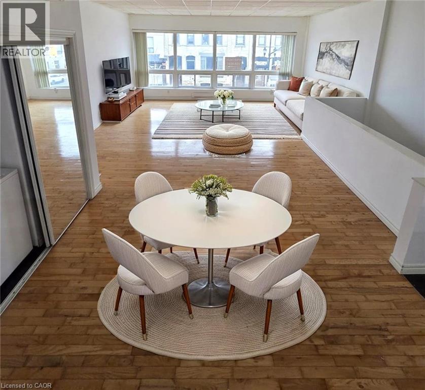 A living room with a white table and chairs in the center.
