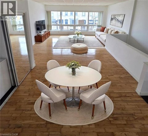 A living room with a white table and chairs in the center.