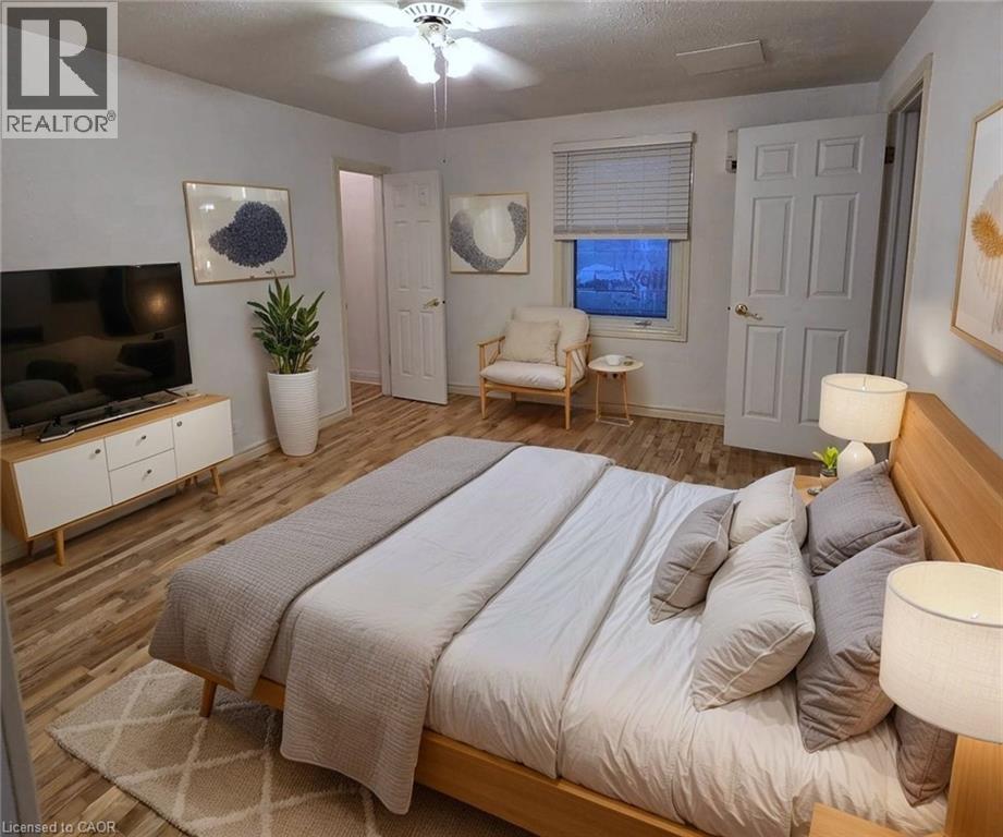 A bedroom with a large bed and a flat screen TV.