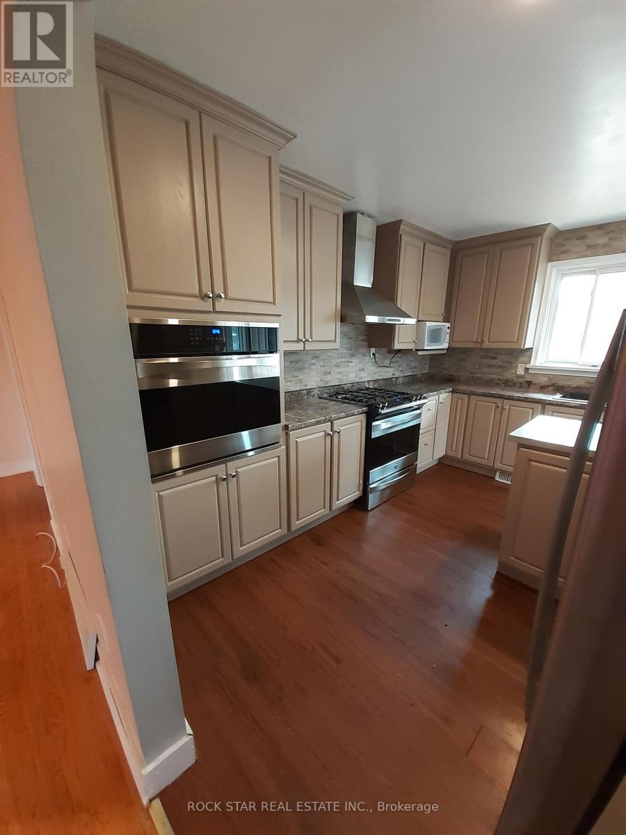 A kitchen with wooden cabinets and a stove top oven.