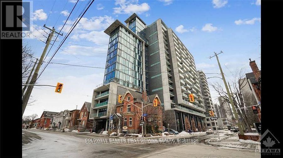 A large building with a glass facade is under construction in a residential area.