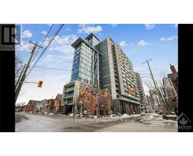 A large building with a glass facade is under construction in a residential area.