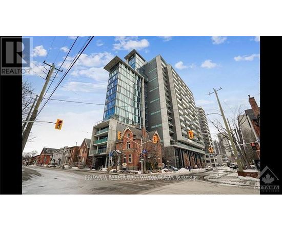 A large building with a glass facade is under construction in a residential area.