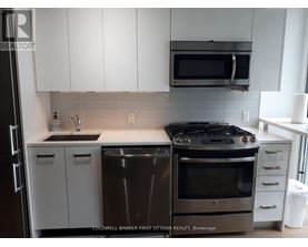 A modern kitchen with a stainless steel dishwasher and oven.