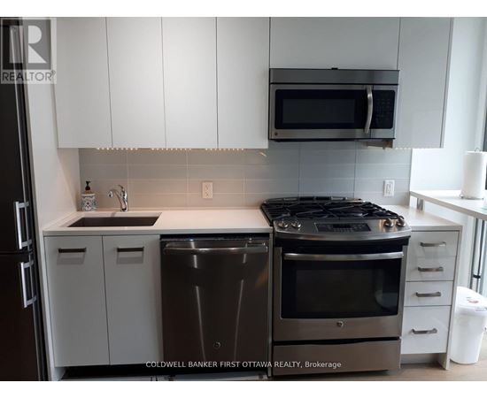 A modern kitchen with a stainless steel dishwasher and oven.