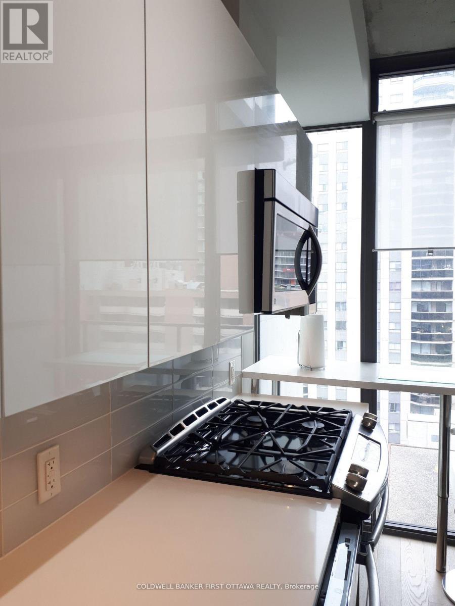 A modern kitchen with a stove top oven and a microwave.