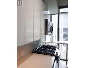 A modern kitchen with a stove top oven and a microwave.