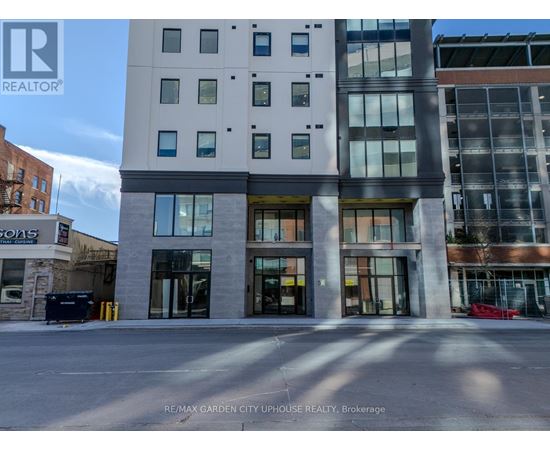 A building with the sign RE/MAX GARDEN CITY UPHOLSTER REALTY, BROKERAGE in front of it.