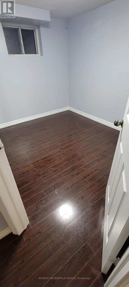 A room with wooden flooring and a window.