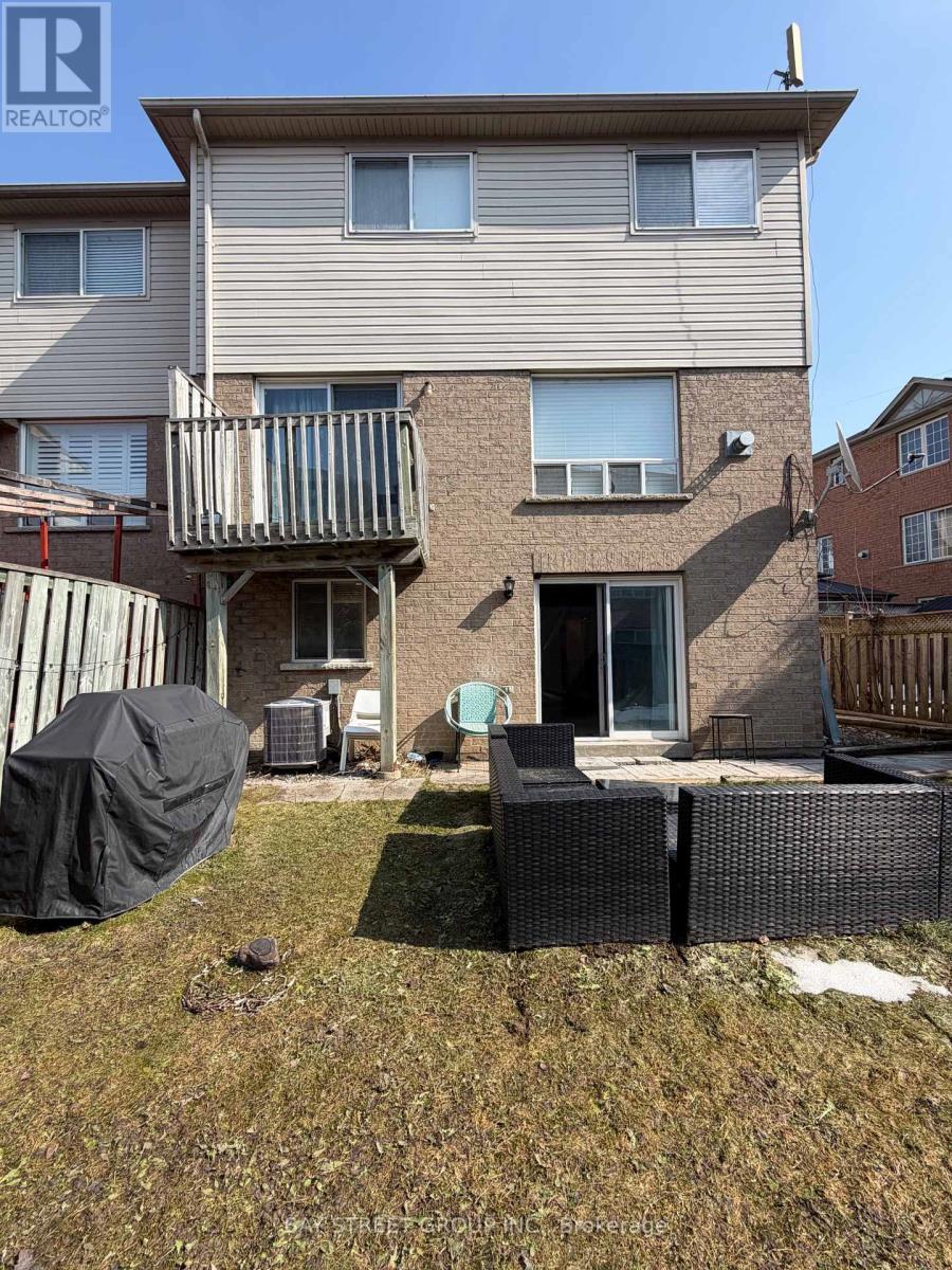 A house with a patio and a black umbrella.