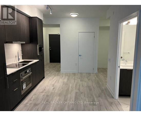 A kitchen with dark wood cabinets and a white countertop.