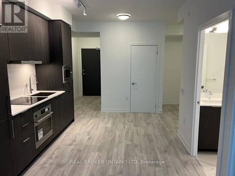 A kitchen with dark wood cabinets and a white countertop.