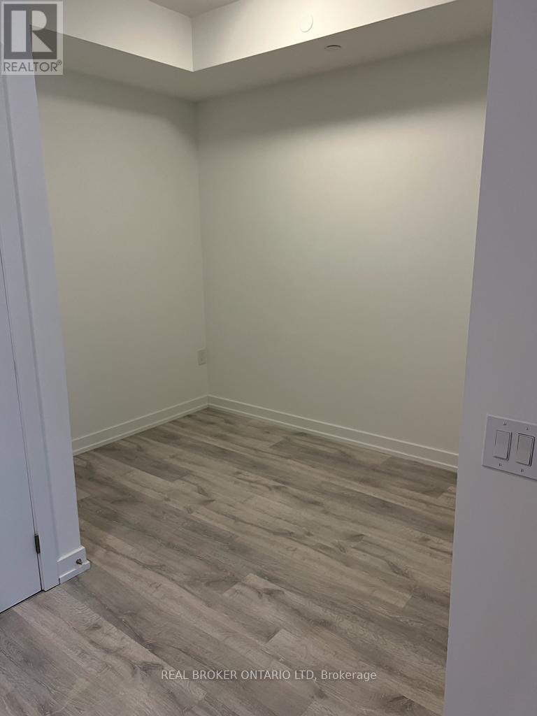 A room with a wooden floor and a white door.