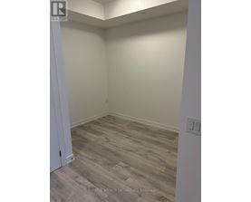 A room with a wooden floor and a white door.