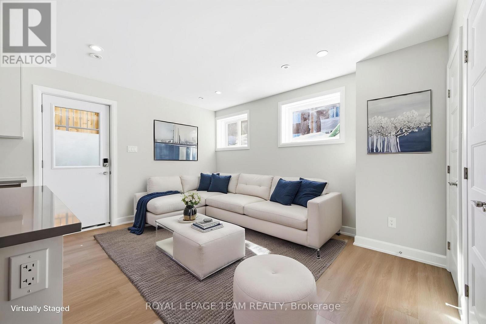 A living room with a white couch and a coffee table.