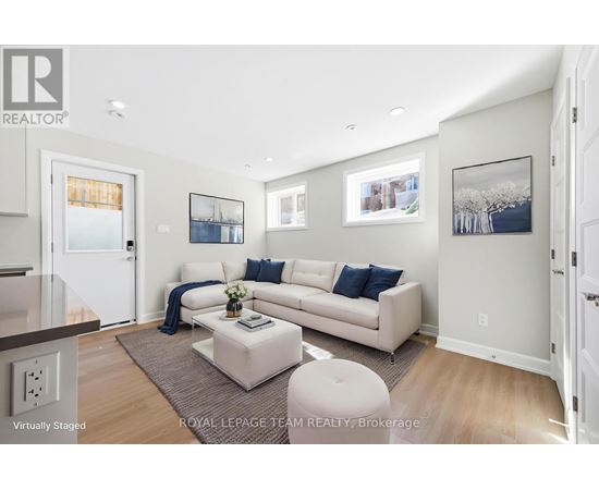 A living room with a white couch and a coffee table.