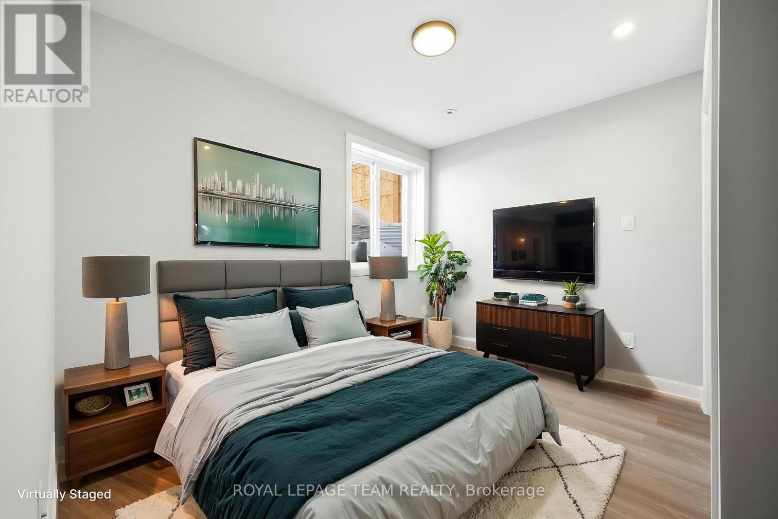 A bedroom with a bed, nightstands, and a painting on the wall.