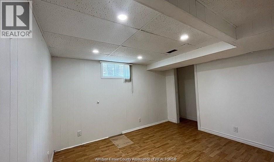 A room with a wooden floor and white walls.