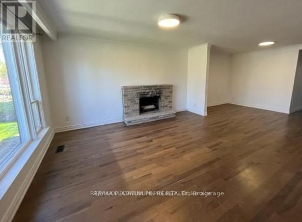 A room with a fireplace and wooden floors.
