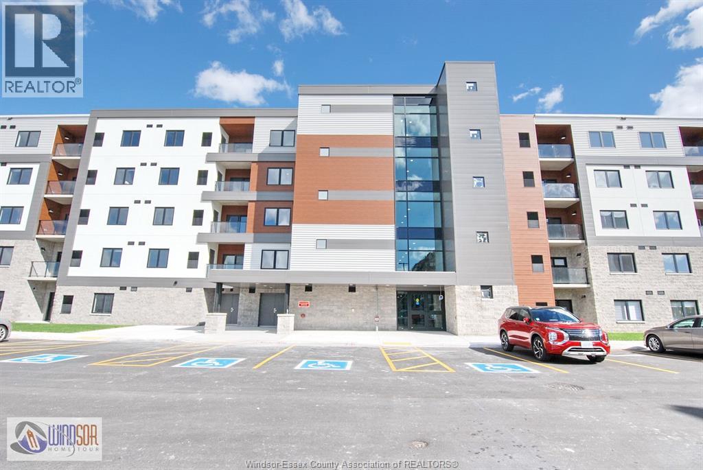 A parking lot in front of a multi-story apartment building.