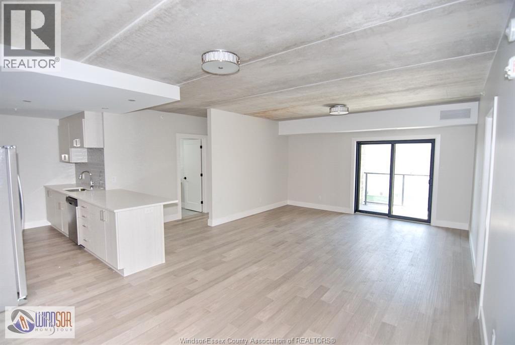 A spacious room with a desk and a window.