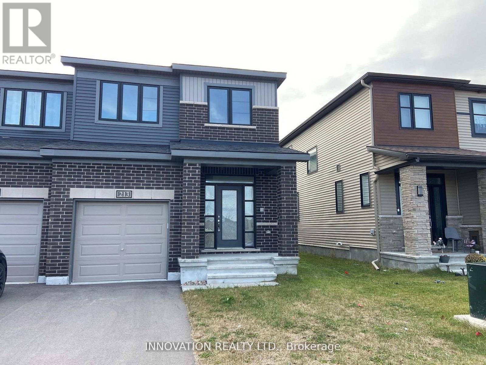 A house with a grey garage door is for sale.