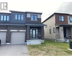 A house with a grey garage door is for sale.