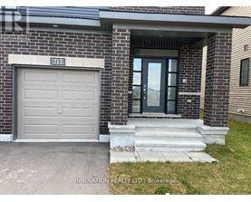 A house with a grey garage door and a glass door entrance.