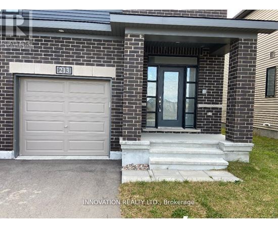A house with a grey garage door and a glass door entrance.