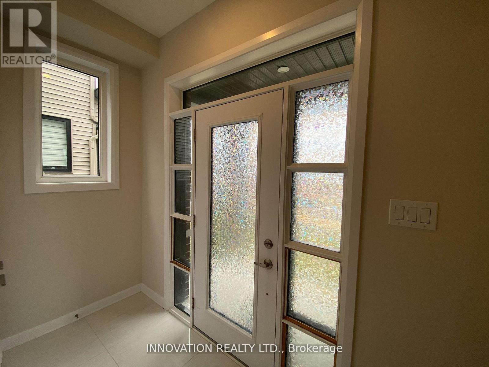 A glass door with a handle is in the middle of a room.