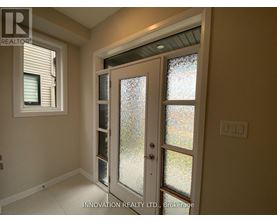 A glass door with a handle is in the middle of a room.