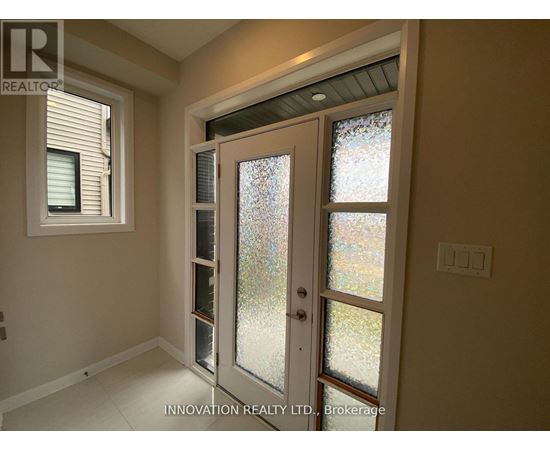 A glass door with a handle is in the middle of a room.