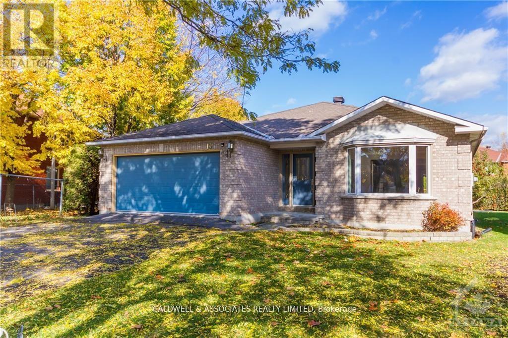 A house with a blue garage door is for sale.