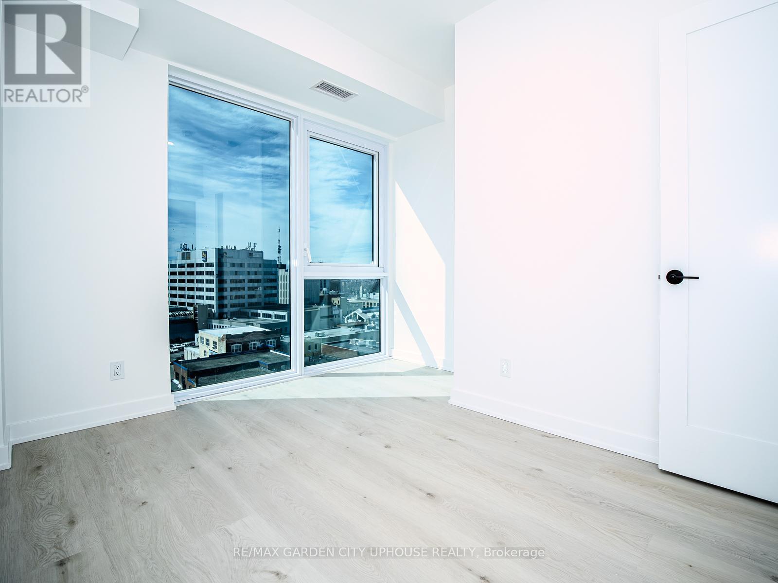 A room with a view of the city through the window.
