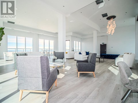A living room with a grey sofa and chairs.