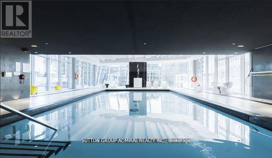 A large indoor swimming pool with a logo on the wall.