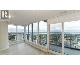 A spacious room with large windows overlooking a cityscape.