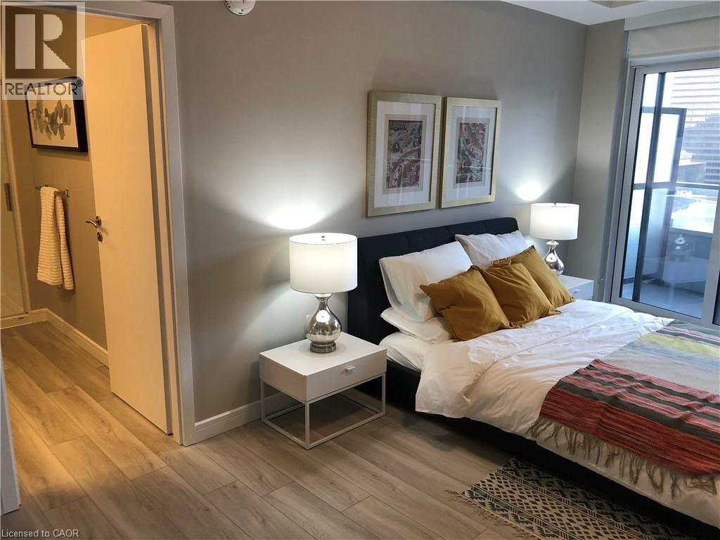 A bedroom with a bed, nightstand, and lamp.
