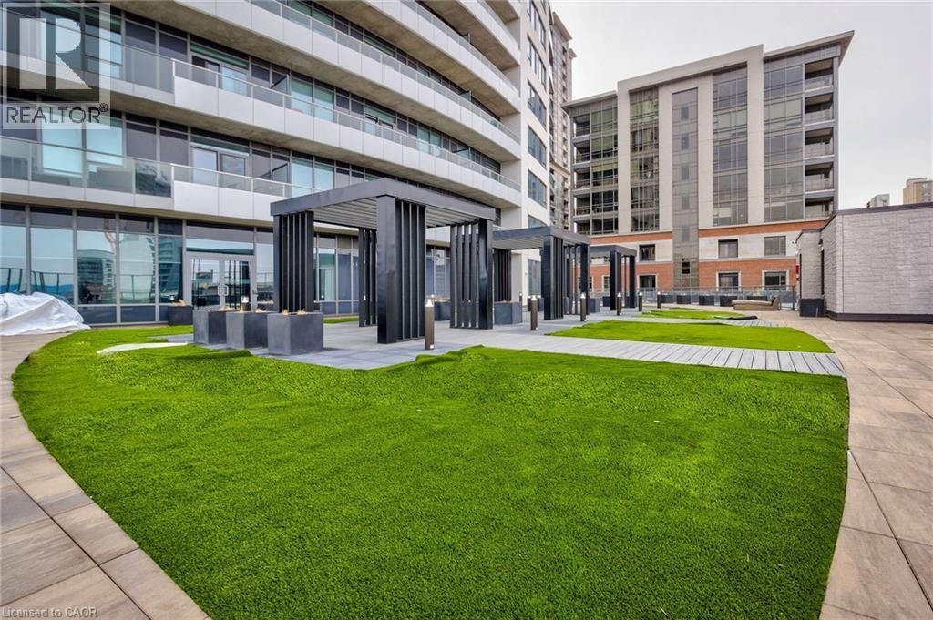 A modern building with a green lawn in front.