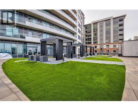 A modern building with a green lawn in front.