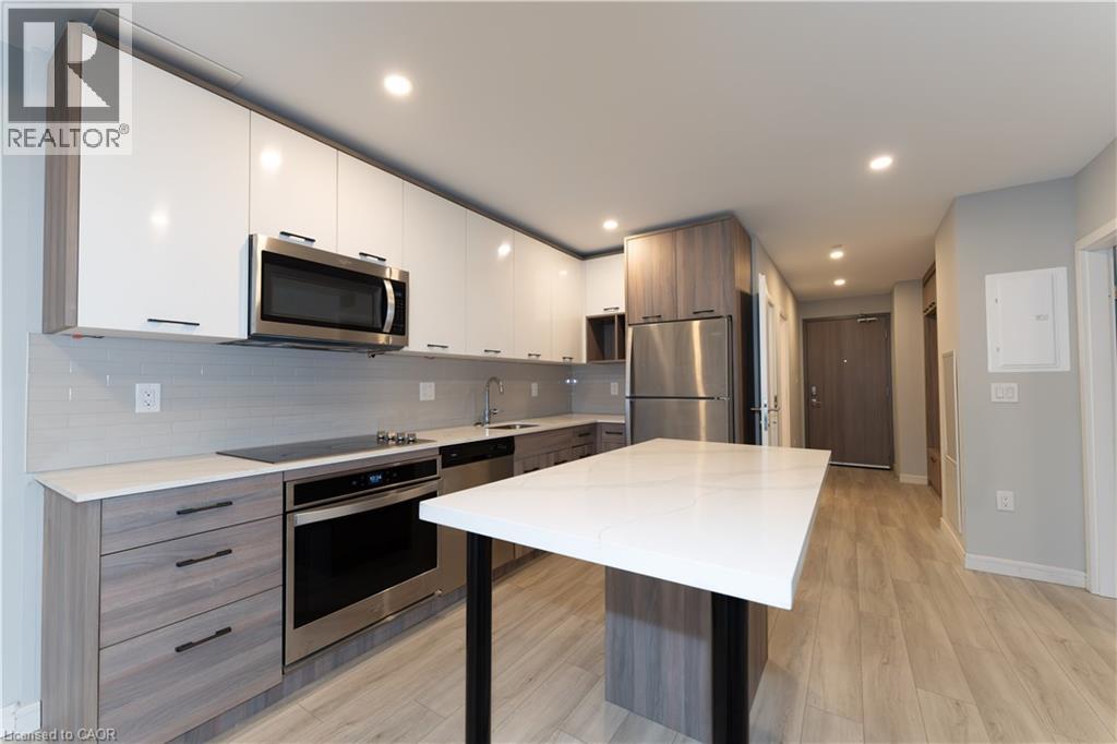 A modern kitchen with a white table and stainless steel appliances.