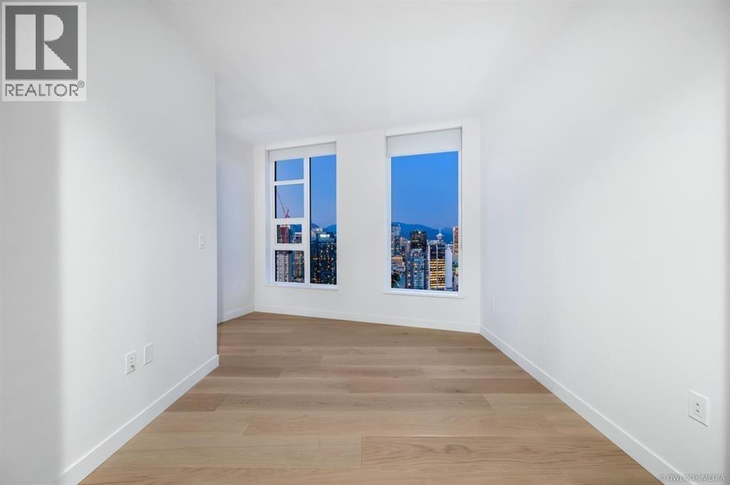A room with a window overlooking a cityscape.