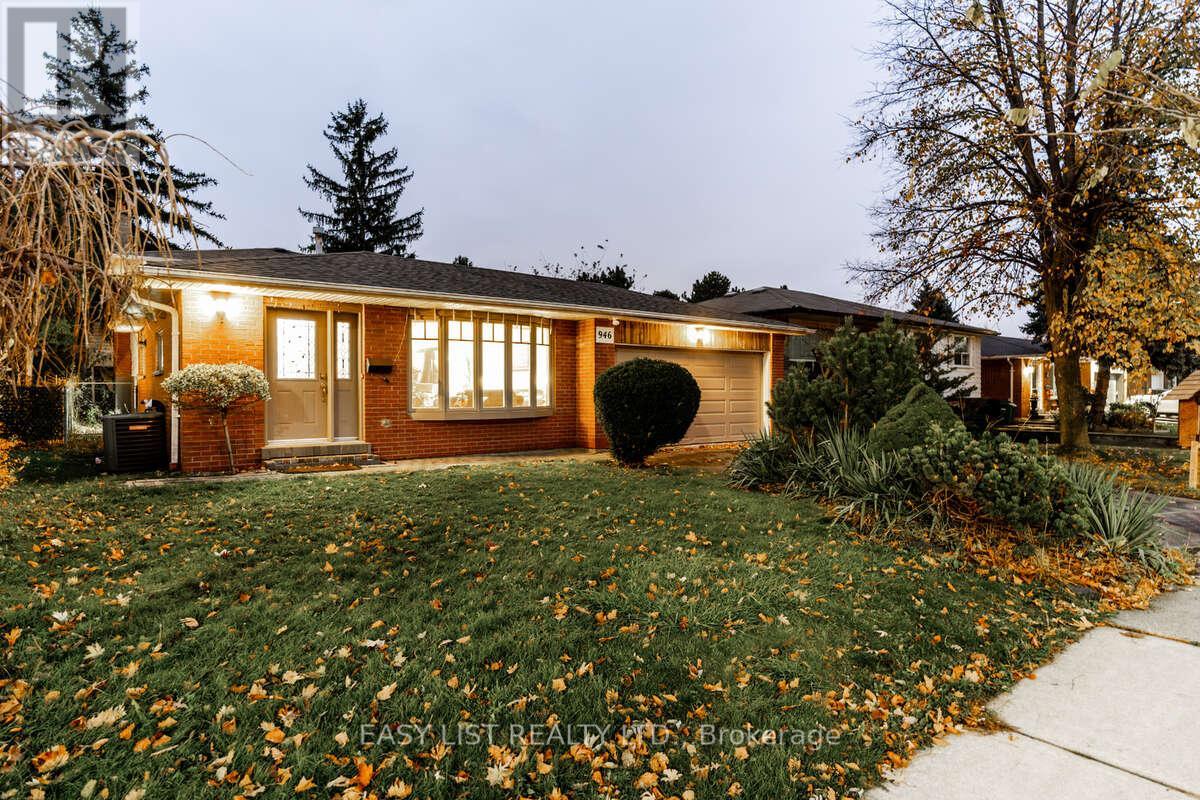 A house with a lawn and trees in front of it.