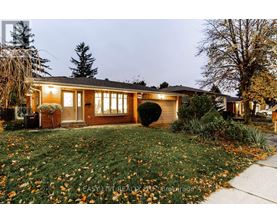 A house with a lawn and trees in front of it.